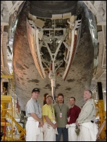 The Fusion crew shot an interview with Space Shuttle Columbia as the backdrop. Pictured (L to R) DP John Ames, PA Mike Thomas, Director Todd Sims, Sound Mixer Joe Hancock, and Gaffer Bill Hennesy.